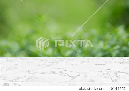 Blank marble table top on green nature abstract bokeh background f 40144352