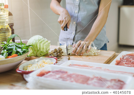 Young asian woman cutting vegetable in the kitchen Young asian woman cutting vegetable in the kitchen 40145078