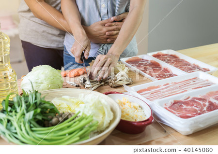 Young asian couple cooking in the kitchen Young asian couple cooking in the kitchen 40145080