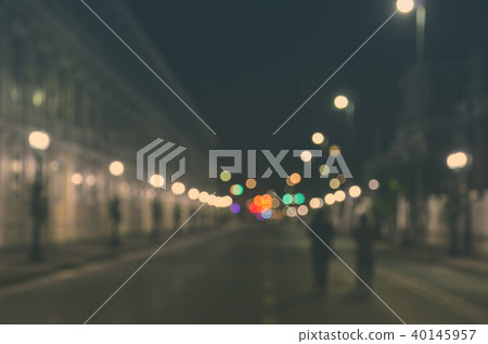 Blurred people walking through a city street Blurred people walking through a city street 40145957