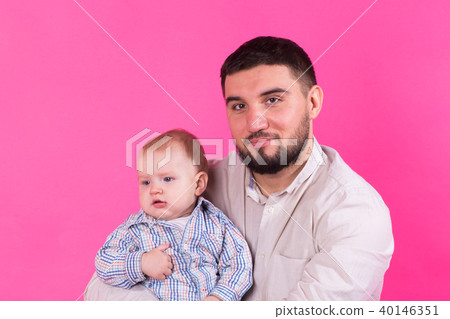 Baby in the daddy hands. Pink background. Baby in the daddy hands. Pink background. 40146351