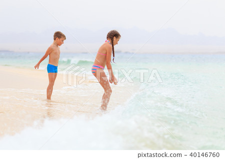 Brother and sister playing together on sea shore Brother and sister playing together on sea shore 40146760