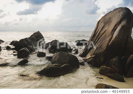 Tropical beach with rock and sea water in sunrise. Tropical beach with rock and sea water in sunrise. 40149955