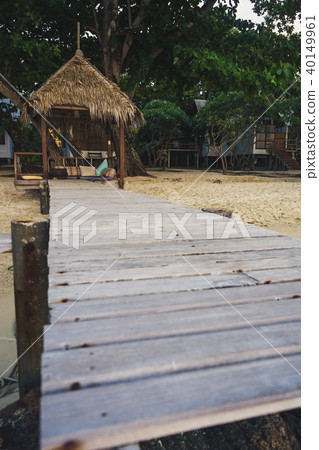 Cottage and wooden pathway with beautiful island. Cottage and wooden pathway with beautiful island. 40149961
