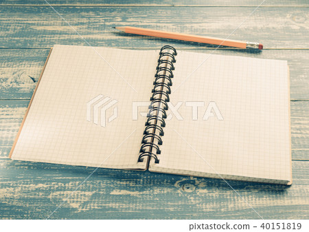 checked notebook on wood 40151819