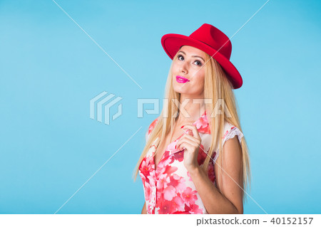 Beautiful woman with long straight blond hair. Fashion model posing at studio on blue background 40152157