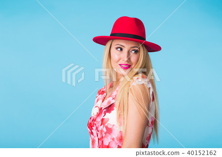 Beautiful woman with long straight blond hair. Fashion model posing at studio on blue background Beautiful woman with long straight blond hair. Fashion model posing at studio on blue background 40152162