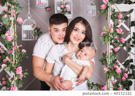 Indoor portrait of asian mixed race family with infant baby Indoor portrait of asian mixed race family with infant baby 40152182