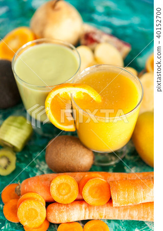 Organic fresh detox smoothies surrounded by fruits and vegetable Organic fresh detox smoothies surrounded by fruits and vegetable 40152700
