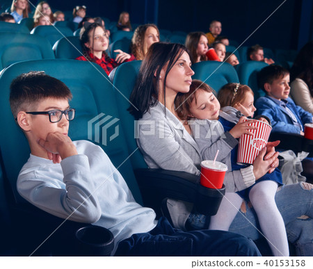 Viewers in cinema watching film with steadfast eyes. 40153158