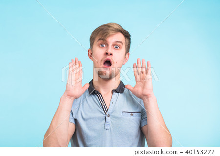 Closeup portrait of shocked stunned surprised young man eyes and mouth wide open, hands in air Closeup portrait of shocked stunned surprised young man eyes and mouth wide open, hands in air 40153272