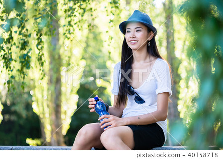 Young Asian woman smiling in the park 40158718