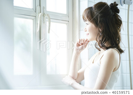 Woman by the window 40159571