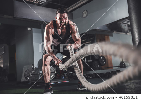 Men with rope in functional training fitness 40159811