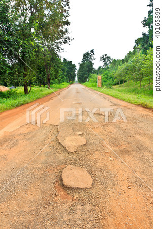 Dilapidated asphalt road 40165899