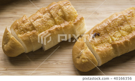 二塊在砧板上已切塊的蒜香麵包 40166356