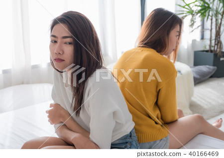 Asia lesbian quarrel sitting each side of bed Asia lesbian quarrel sitting each side of bed 40166469