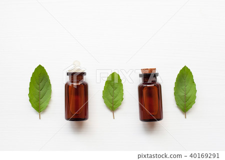 Holy basil essential oil with leaves. Holy basil essential oil with leaves. 40169291