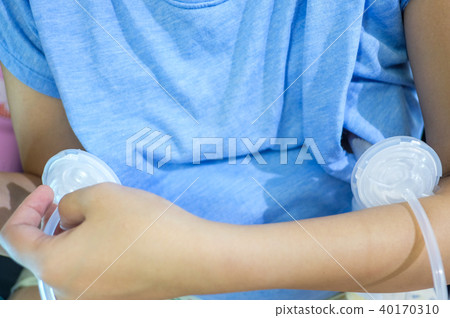 Automatic breast pump on both side of her breast Automatic breast pump on both side of her breast 40170310