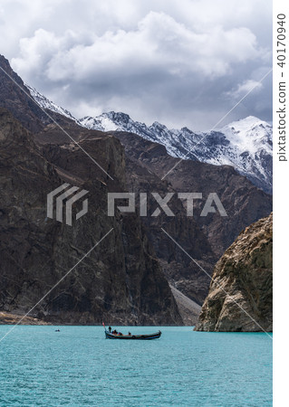Attabad lake and rocky mountain with local boat 40170940