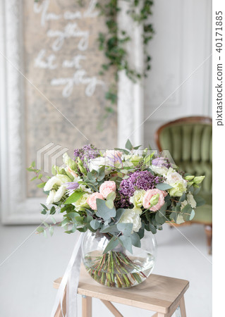 Beautiful luxury bouquet of mixed flowers in glass vase. the work of the proffesional florist at a 40171885