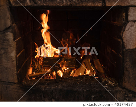 Burning woods in old fireplace 40174457