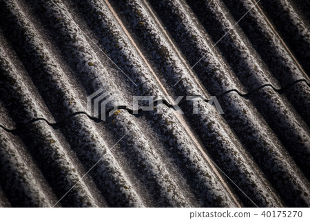 The texture of a voluminous slate on an old roof close up. The texture of a voluminous slate on an old roof close up. 40175270