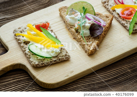 Healthy sandwiches with fresh vegetables.  40176099