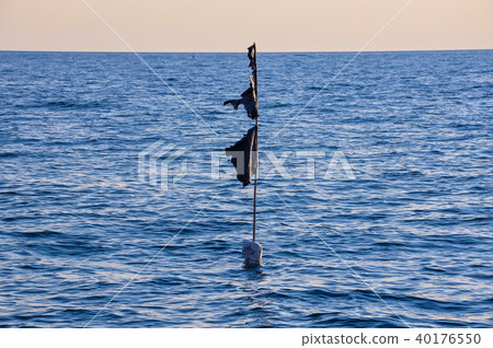 black buoy in the sea 40176550