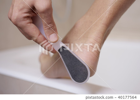 young man using a foot rasp 40177564