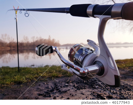Fisherman's reel, mounted on a fishing rod. 40177943