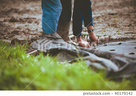 farmer with rake prepares the ground farmer with rake prepares the ground 40179142
