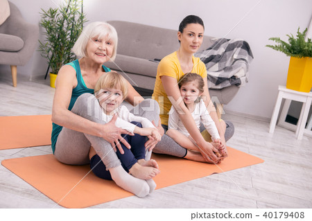 Smiling women and kids doing yoga Smiling women and kids doing yoga 40179408