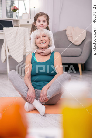 Smiling girl hugging her grandmother 40179428