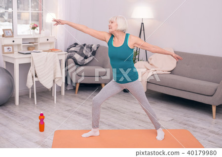 Cheerful elderly woman exercising in the morning Cheerful elderly woman exercising in the morning 40179980