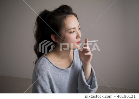 Young woman smoking Young woman smoking 40180121