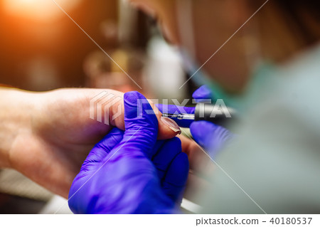 Nail care in salon. Selective focus on costumer's nails. Selective focus. 40180537