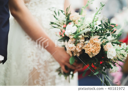 Beauty wedding bouquet with different flowers in hands 40181972