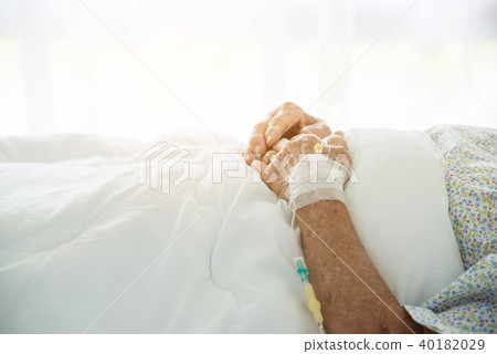 Hands of senior patient lying on bed in hospital 40182029