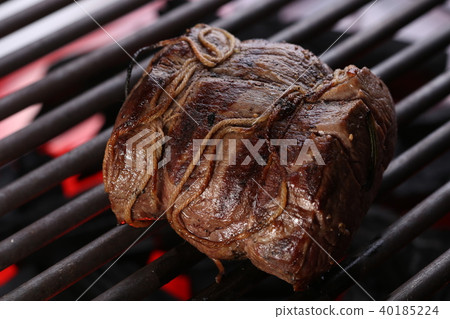 Appetizing pork steak on the grill. Close up Appetizing pork steak on the grill. Close up 40185224