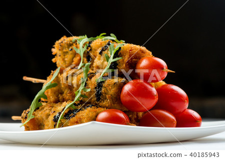 vegetables on skewer fried in batter decorated with tomatoes zucchini, eggplant, zucchini. white 40185943