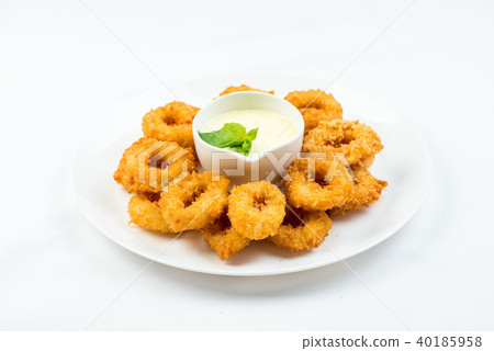 Squid rings fried in batter with white sauce on white plate on white background 40185958