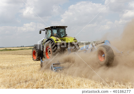 Tractor plowing field at summer Tractor plowing field at summer 40186277
