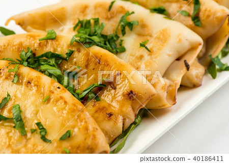 body of squid fried with lemon on white plate on white background body of squid fried with lemon on white plate on white background 40186411