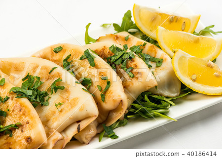 body of squid fried with lemon on white plate on white background 40186414