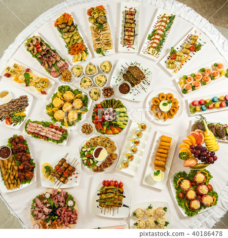 Different snacks for eating on holiday in white plates on white background. Kitchen, menu, food 40186478