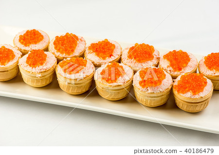 Tartlets with cheese and red caviar. Selective focus. Copy space 40186479