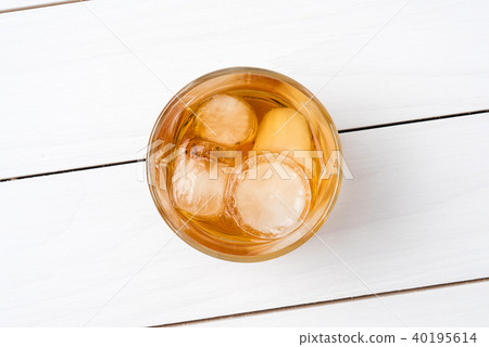Whiskey glass on white wooden table. Top view Whiskey glass on white wooden table. Top view 40195614