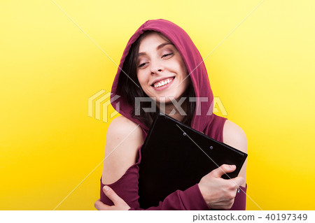 Smiling woman wearing a hood holds a black folder in hands 40197349