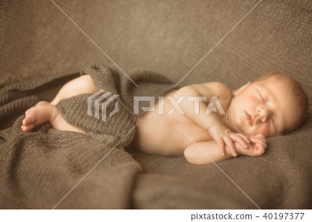 Little sleeping newborn baby in wrap creamy Little sleeping newborn baby in wrap creamy 40197377